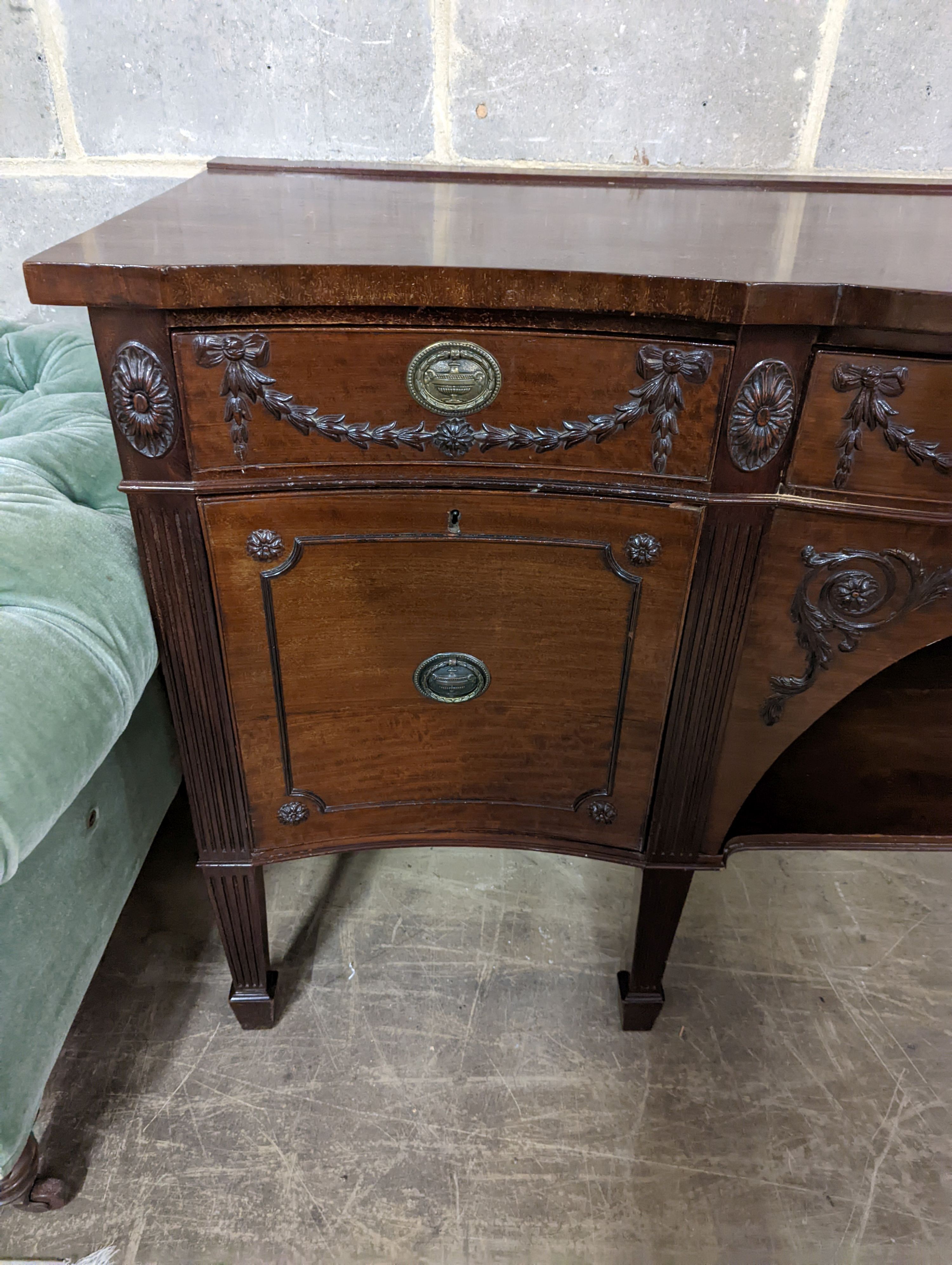 An early 20th century Adam design mahogany serpentine sideboard, length 214cm, depth 68cm, height 92cm